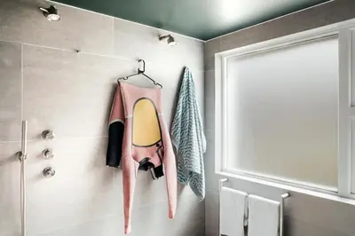 a bathroom with a surfboard hanging on the wall at 6 Barnaloft in St Ives