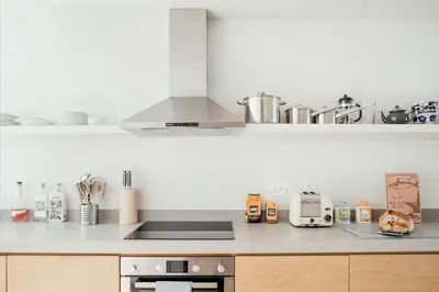 a kitchen with a counter top with a stove top oven at 6 Barnaloft in St Ives