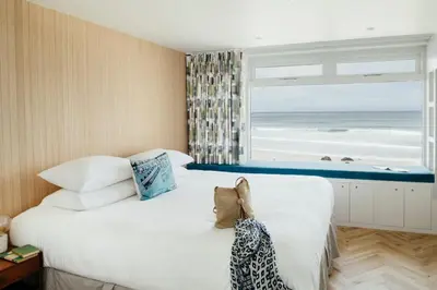 a bedroom with a bed with a view of the ocean at 6 Barnaloft in St Ives
