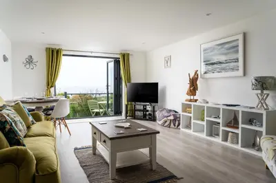 a living room with a couch and a table at Seasky in Praa Sands
