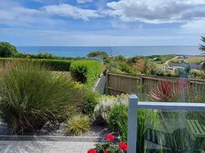 a garden with a view of the ocean at Seasky in Praa Sands