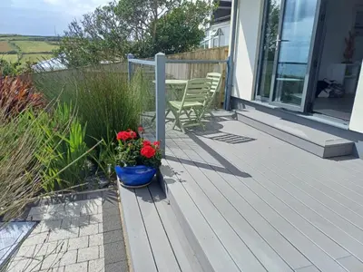 a porch of a house with a blue pot of flowers at Seasky in Praa Sands