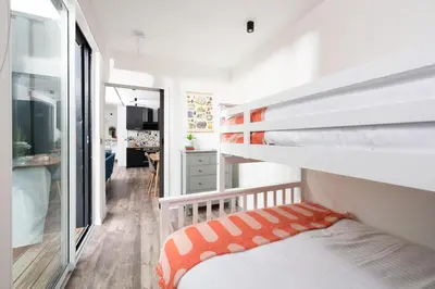 a small room with a bunk bed and a hallway at Trevassack Holidays in Helston
