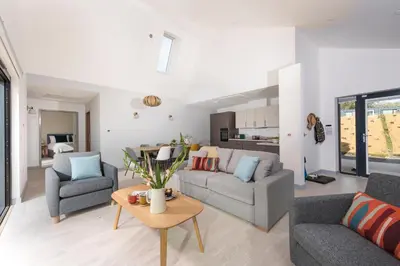 a living room with two couches and a table at Trevassack Holidays in Helston