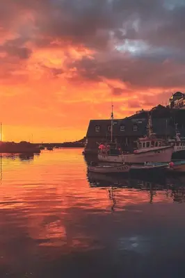 a group of boats sitting in the water at sunset at Holiday Home The Old Inn by Interhome in Pentewan
