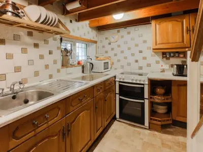 a kitchen with a sink and a stove at Holiday Home The Old Inn by Interhome in Pentewan