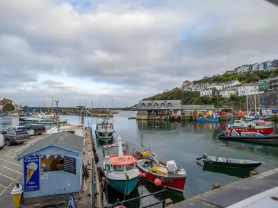 a group of boats are docked in a harbor at Apartment Jetty Cottage by Interhome in Mevagissey
