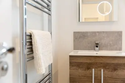 a bathroom with a sink and a mirror at Ground Floor Couples Retreat in Newquay