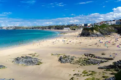 a group of people on a beach near the ocean at Ground Floor Couples Retreat in Newquay