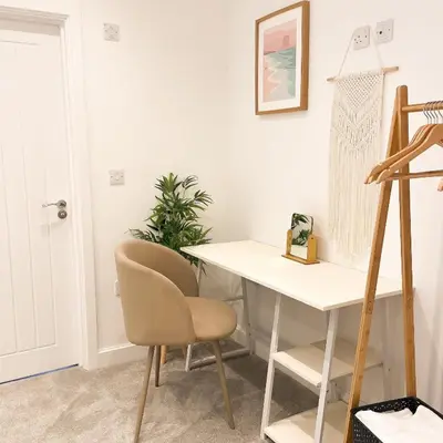 a desk and a chair in a room at Ground Floor Couples Retreat in Newquay