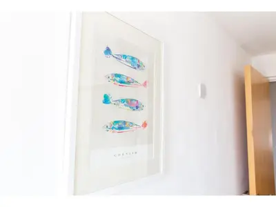a picture of fishes in a frame on a wall at Modern Apartment Sea Views Private Parking in Newquay