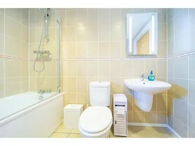 a bathroom with a white toilet and a sink at Modern Apartment Sea Views Private Parking in Newquay