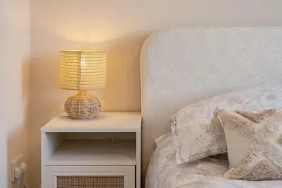 a lamp on a night stand next to a bed at Cosy Apartment Parking Central Newquay in Newquay