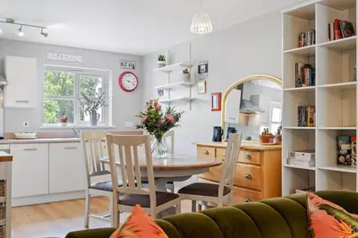 a kitchen and dining room with a table and chairs at Modern Townhouse in Penryn with Private Parking in Penryn