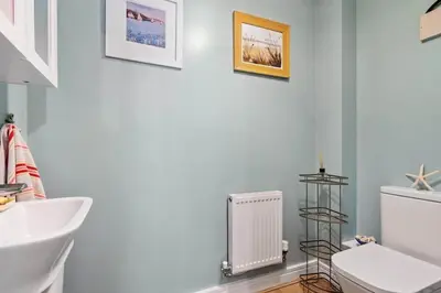 a bathroom with a white toilet and a radiator at Modern Townhouse in Penryn with Private Parking in Penryn