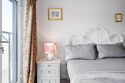 a bedroom with a bed and a night stand with a lamp at Modern Townhouse in Penryn with Private Parking in Penryn