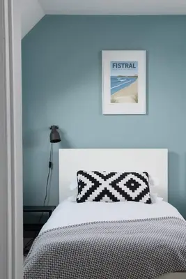 a bedroom with a white bed and a picture on the wall at Family Home in Newquay Parking 3 mins to Beach in Newquay
