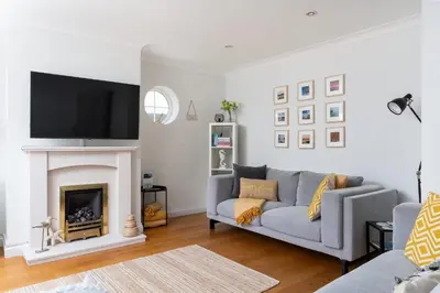 a living room with a couch and a fireplace at Family Home in Newquay Parking 3 mins to Beach in Newquay