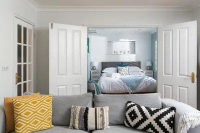 a living room with a couch and a bed at Family Home in Newquay Parking 3 mins to Beach in Newquay