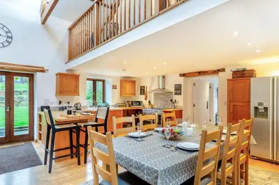a kitchen and dining room with a table and chairs at 4 Bed in Torpoint oc-m30122 in Downderry