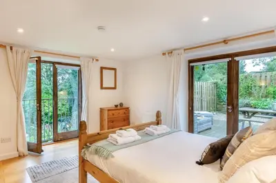 a bedroom with a bed with two towels on it at 4 Bed in Torpoint oc-m30122 in Downderry