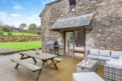 a patio with a picnic table and a grill at 4 Bed in Torpoint oc-m30122 in Downderry