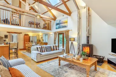 a living room with a couch and a fireplace at 4 Bed in Torpoint oc-m30122 in Downderry