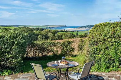 a table and chairs on a patio with a view at 5 Bed in St. Issey oc-r4328 in Saint Issey