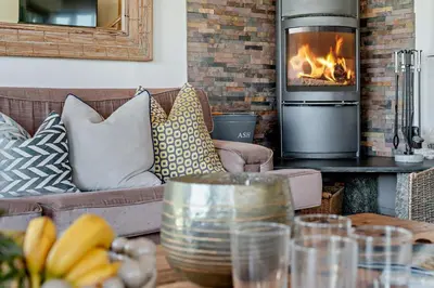 a living room with a couch and a fireplace at 5 Bed in St. Issey oc-r4328 in Saint Issey