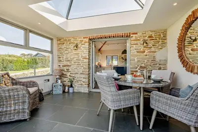 a dining room with a table and chairs at 5 Bed in St. Issey oc-r4328 in Saint Issey