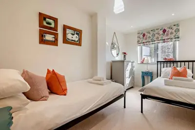 a bedroom with two beds with orange pillows at 5 Bed in St. Issey oc-r4328 in Saint Issey