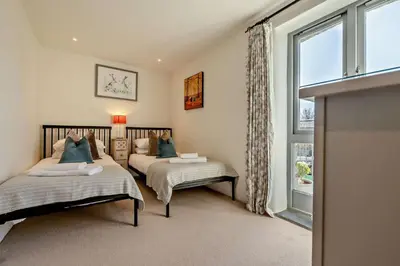 a bedroom with two beds and a window at 5 Bed in St. Issey oc-r4328 in Saint Issey