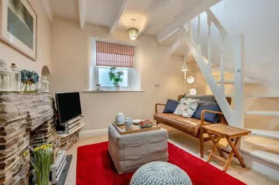 a living room with a couch and a fireplace at 1 Bed in Padstow oc-s30202 in Padstow