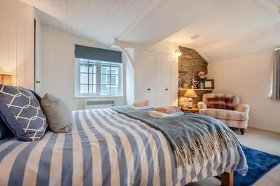 a bedroom with a bed with a striped blanket at 1 Bed in Padstow oc-s30202 in Padstow
