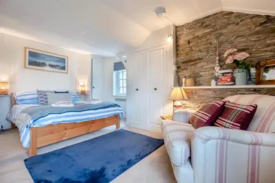 a bedroom with a bed and a couch at 1 Bed in Padstow oc-s30202 in Padstow