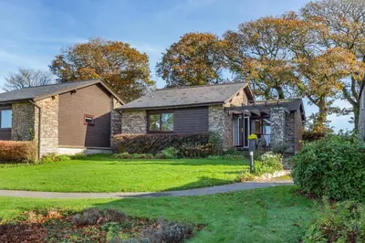 a brick house with a grass yard at 2 Bed in Tywardreath oc-a30310 in Tywardreath