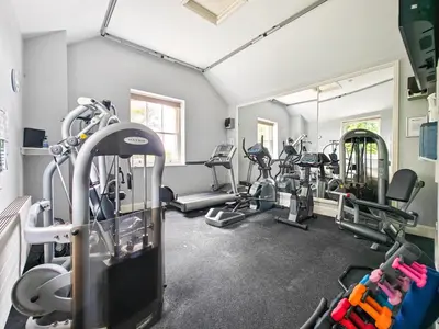 a gym with treadmills and ellipticals in a room at 2 Bed in Tywardreath oc-a30310 in Tywardreath