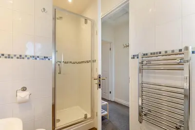 a bathroom with a shower with a glass door at 2 Bed in Tywardreath oc-a30310 in Tywardreath