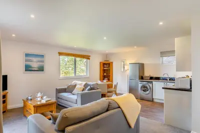 a living room with a couch and a kitchen at 2 Bed in Tywardreath oc-a30310 in Tywardreath