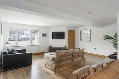 a living room with a couch and a tv at Ranalegh Court in Saint Columb Minor