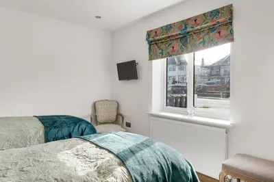 a bedroom with a bed and a window at Ranalegh Court in Saint Columb Minor