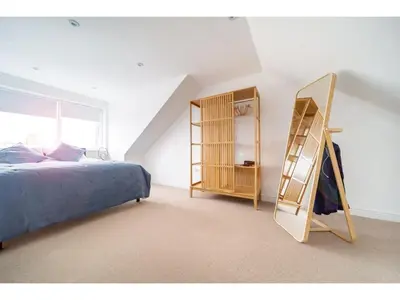 a bedroom with a ladder next to a bed at Spacious Home Private Parking Central Newquay in Newquay
