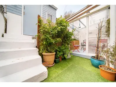 a porch with potted plants on the side of a house at Spacious Home Private Parking Central Newquay in Newquay