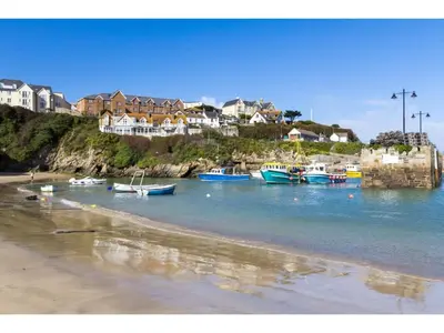 a group of boats in the water near a beach at Spacious Home Private Parking Central Newquay in Newquay