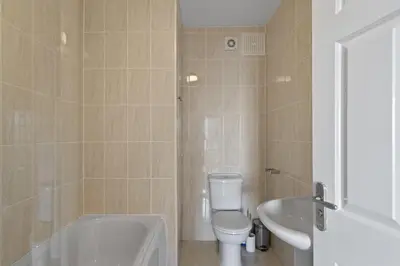 a bathroom with a tub and a toilet and a sink at Apartment Sea Views & Terrace on Waters Edge in Polruan in Polruan