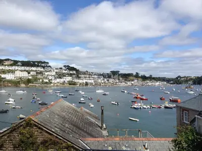 a harbor filled with lots of boats in the water at Apartment Sea Views & Terrace on Waters Edge in Polruan in Polruan
