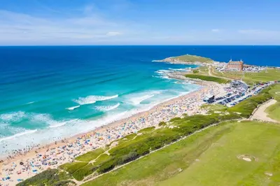 an aerial view of a beach with crowds of people at Modern Apartment nr Fistral Beach Private Parking in Newquay