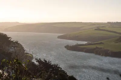 a view of a body of water with hills at Modern Apartment nr Fistral Beach Private Parking in Newquay
