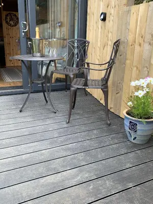 a table and a chair on a porch at The Lookout in Padstow