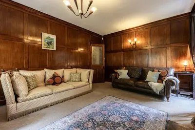 a living room with two couches and a rug at Large Grade II Listed House & Garden nr Beaches in Saint Columb Major
